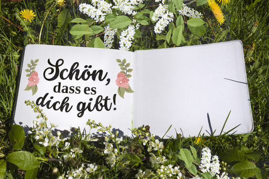 Eco friendly spring mockup with German quote "Sch&ouml;n dass es dich gibt" in sketchbook on green grass background