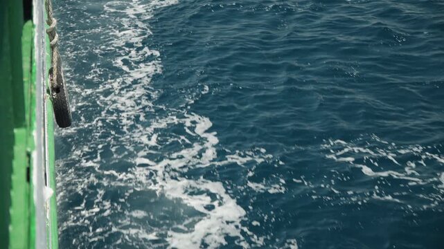 Sea wave activity. Vigorous maritime water motion. Powerful sea spray and turbulent wake during coastal transit. Energetic ocean waves crashing with foam spray and textured water patterns