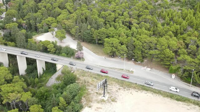 Traffic jam on a road in Croatia during the summer holiday season. Cars slowly drive along the road among the Croatian mountains.