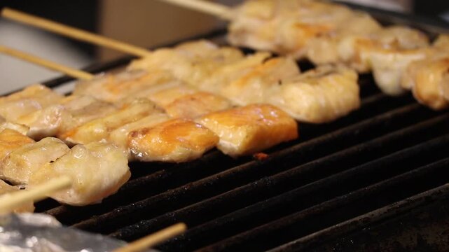 Grilled Salmon Belly Skewers Sizzling on a Charcoal Grill