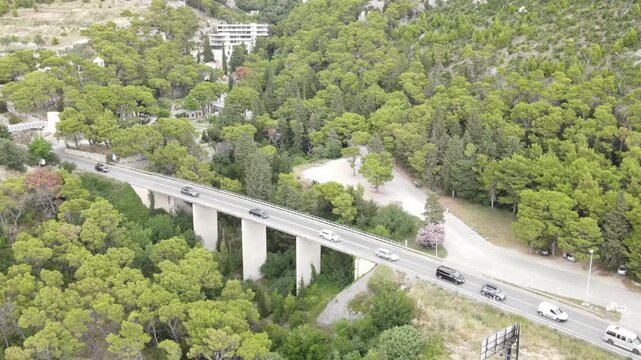 Traffic jam on a road in Croatia during the summer holiday season. Cars slowly drive along the road among the Croatian mountains.
