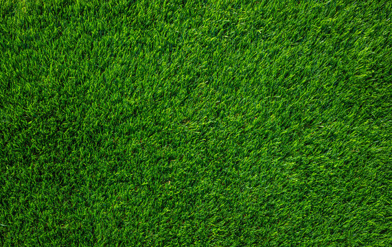 Bright green artificial grass lawn turf texture background