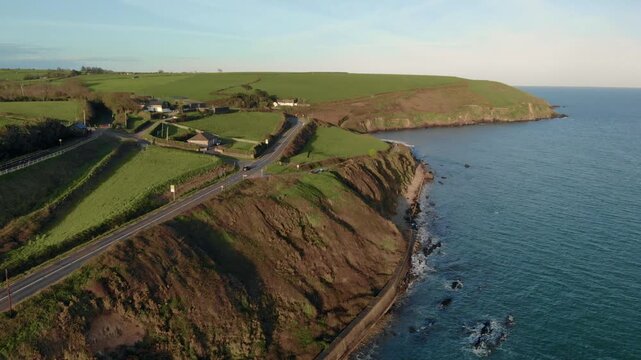 Drone glides smoothly over Irish cliffside, showcasing serene coastal scenery and peaceful atmosphere, perfect for travel and wellness campaigns.