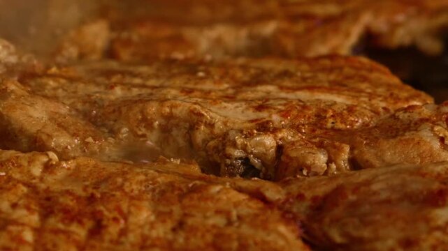 Close Up of Meat Cooking in Hot Oil, Juicy Steak Frying with Bubbling Fat Macro Shot.