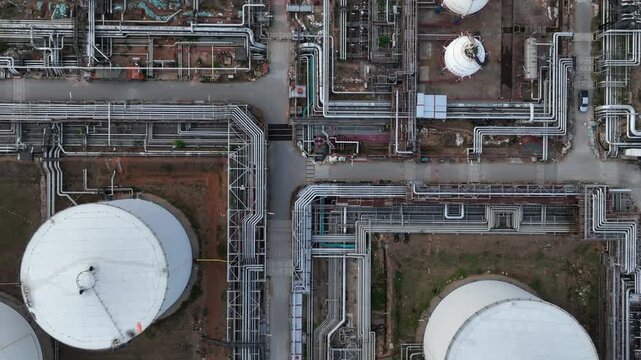 Aerial view white oil storage tank with pipeline steel, Crude oil industry, Storage fuel gas container tank petroleum refinery industrial factory, Oil storage chemical petrochemical refinery product.
