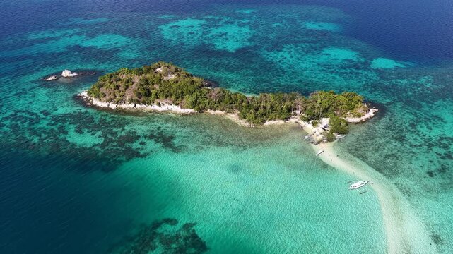 A sinuous sand bank stretches out from Snake Island in Bacuit Bay near El Nido, Philippines. This idyllic spot is a popular tourist destination and is a wonderful place to swim.