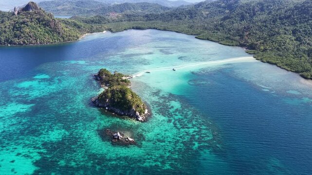 A sinuous sand bank stretches out from Snake Island in Bacuit Bay near El Nido, Philippines. This idyllic spot is a popular tourist destination and is a wonderful place to swim.