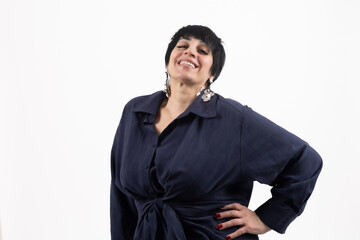 Obraz premium Mature woman in dark blue shirt posing with hand on hip