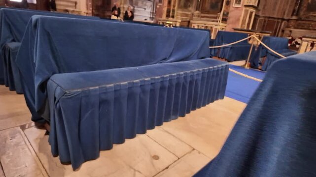Church pews decorated with blue ceremonial fabric in San Pietro in Montorio