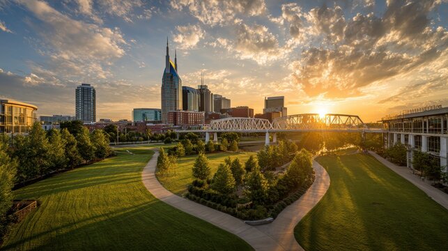 Nashville skyline at sunset with cumberland river and pedestrian bridge