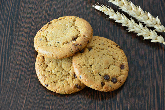 Chocolate Chip Cookies with Wheat on Wooden Table close up