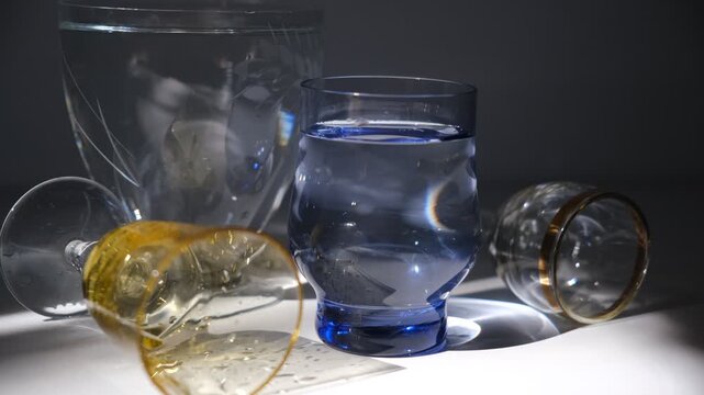 Drinking glasses. Buffet. Various glasses for alcohol and soft drinks. Dark, refraction light. Bar counter