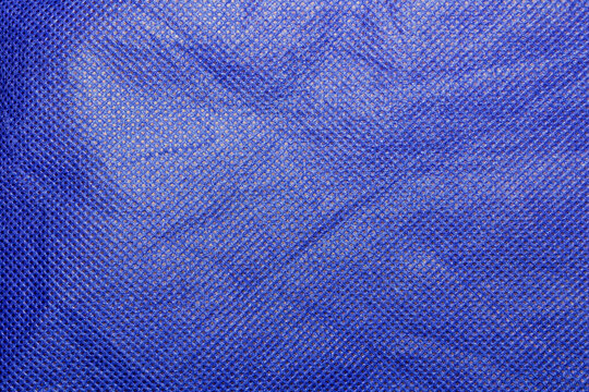 Rippled Blue Nonwoven Spunbond Polypropylene Fabric Texture Background - The Rugged Texture Offers a Strong Visual Aesthetic, Suitable for Fashion Design, Mockups, Posters and Creative Projects.