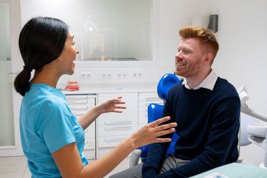 Dentist and patient discussing dental care during a consultation in a modern clinic