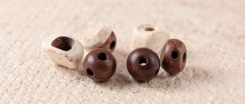 A collection of wooden beads arranged on a flat surface, great for decorative or educational purposes
