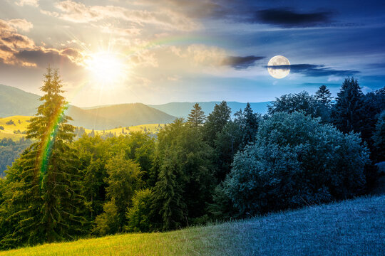 day meet night on mountain hay field. sun and moon over alpine countryside summer landscape with green valley behind the woods on the grassy slope at twilight. cloudy sky. epic highland background