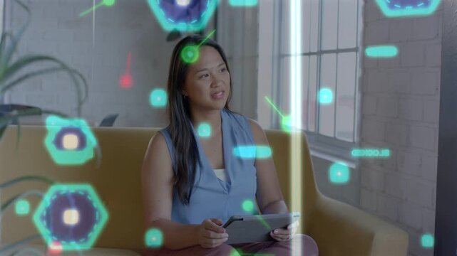 Woman sitting on sofa using tablet stylus, hearing audio cue, reviewing tech overlay occluding face