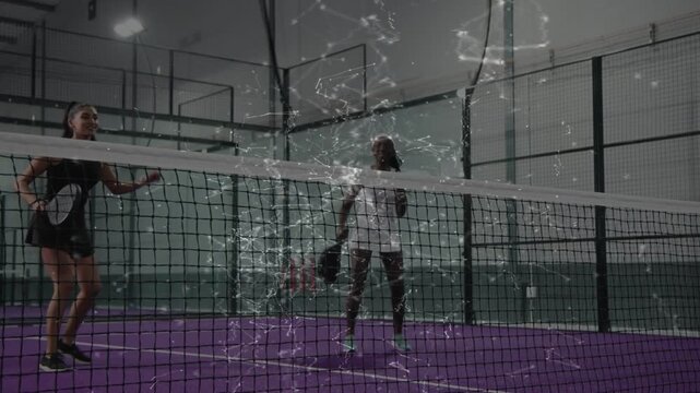 Two female padel players practicing drill, reacting to incoming ball, volleying, overlay persisting