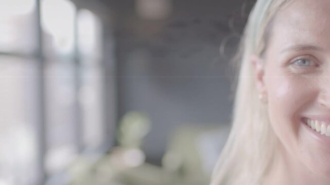 Woman smiling, shifting into frame after vertical dark band passes, revealing marketing close-up