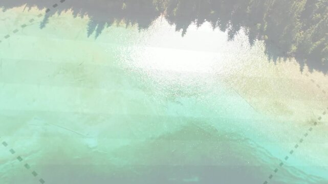 Drone starting low over aqua rising inland and showing shoreline forest dashed overlay for mapping