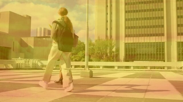 Woman raising arm and greeting peer on tiled plaza, animated map guiding backpacks for education