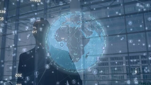 Male business traveler walking, raising hand, activating rotating AR globe while viewing data nodes