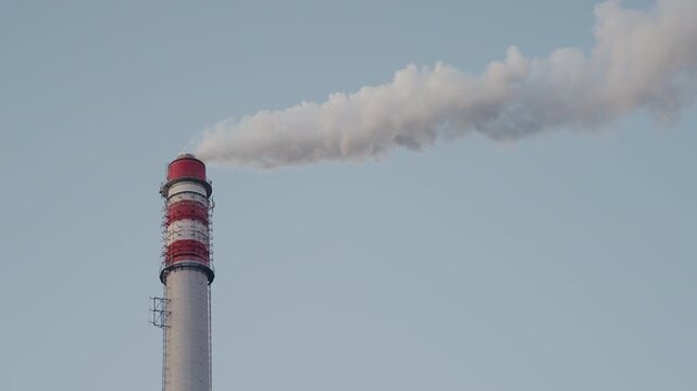 Industrial Smokestack Emitting Smoke Air Pollution Into The Sky. District heating boilers, Bioenergy