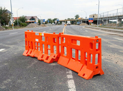 Barriers sitting idle on a road, possibly for construction or maintenance purposes