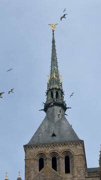 Visit to the church tower in Normandy showing the detailed architecture against the sky