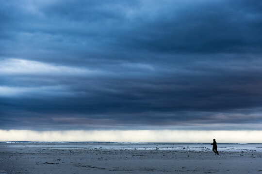 stormy clouds hover over lagoon and san beach, Hermanus, South Africa