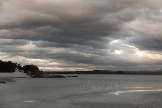 stormy clouds hover over lagoon and san beach, Hermanus, South Africa