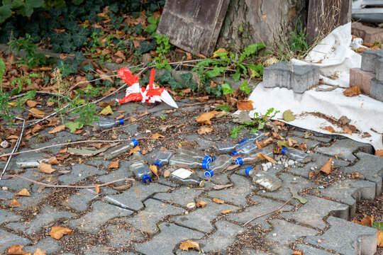 Small empty bottles on the street in big city after drinking party.