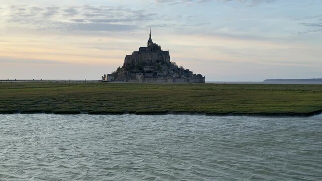 View of Mont Saint Michel in Normandy during sunset near the water