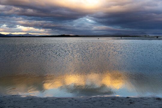 stormy clouds hover over lagoon and san beach, Hermanus, South Africa