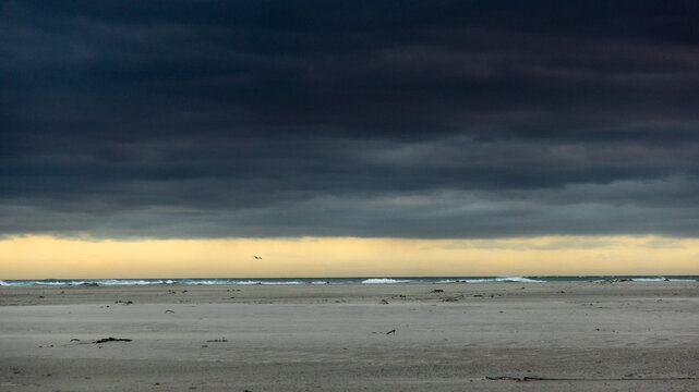 stormy clouds hover over lagoon and san beach, Hermanus, South Africa