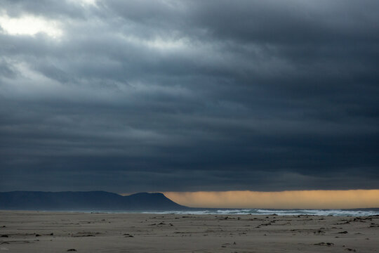 stormy clouds hover over lagoon and san beach, Hermanus, South Africa