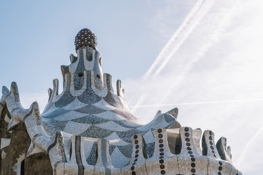 Low angle view of Gaudi architecture in Park Guell with mosaic details and blue sky