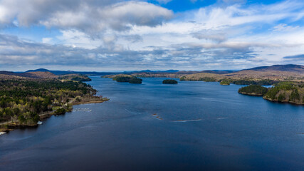Obraz premium Tupper Lake, NY, USA - April 29, 2026 Aerial photo captures the Raquette river and surrounding wetlands of Tupper Lake in New York's Adirondack Mountains.