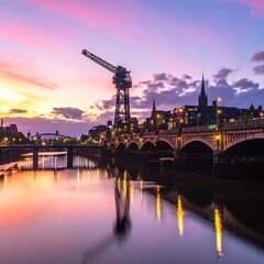 Obraz premium A serene cityscape at sunset with a bridge over a river