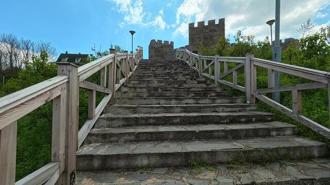 Stone steps lead upward to a fortress wall.  Ram Fortress, Serbia