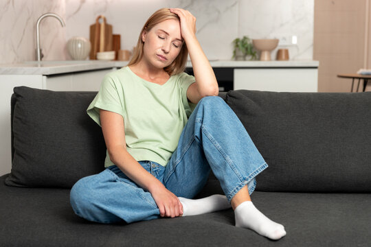Tired woman having headache, suffering from mental disorder