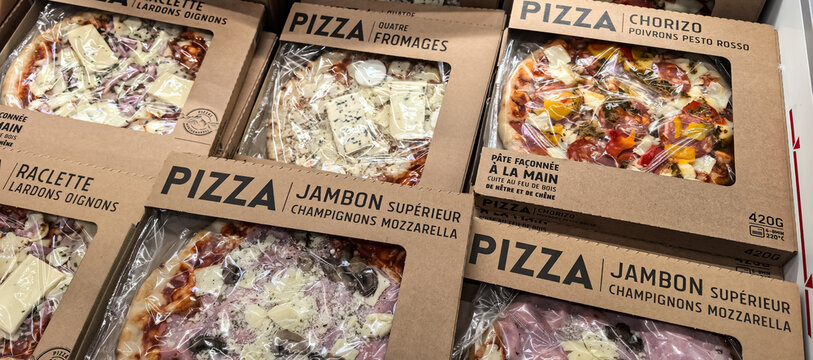 Packaged fresh pizza in supermarket ready meal section 