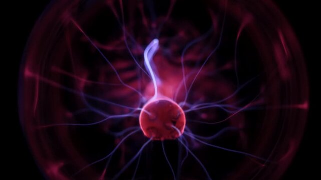 Dynamic plasma ball discharge with blue and purple neon lightning in motion