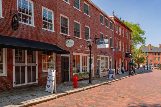 Newburyport, MA, US - September 13, 2022: Street scene in downtown of this small town with its quaint streets with 19th century brick buildings and trendy shops and restaurants.