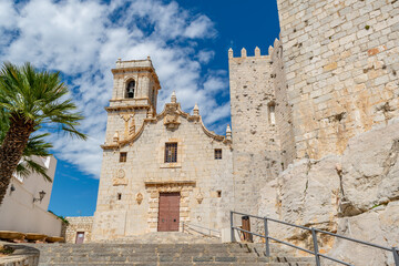 Fototapeta premium White colonial church bell tower blue sky Spanish town Spain