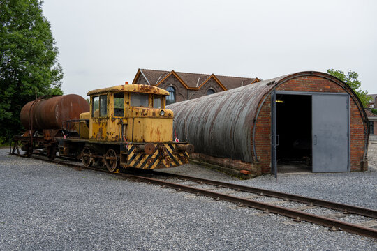 Rusty industrial locomotive at Bois du Cazier museum railway