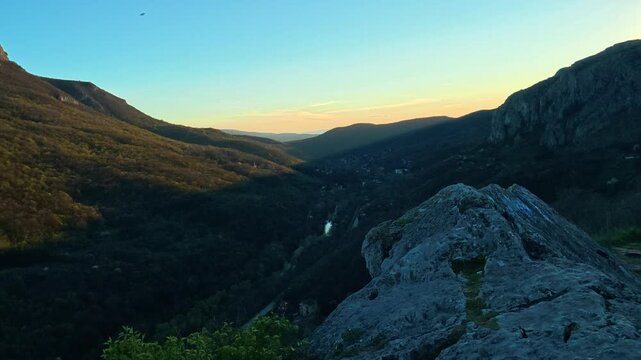 Rugged stone overlooks deep valley at golden hour. Sicevo Gorge, Serbia