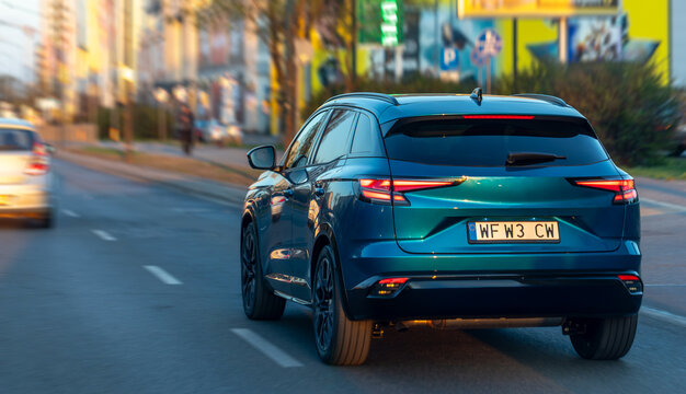 Dark blue crossover driving on a city street. Dynamic shot of a modern car in the city.