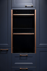 Fototapeta premium Built-in oven in dark blue cabinets. Elegant kitchen furniture with copper handles.