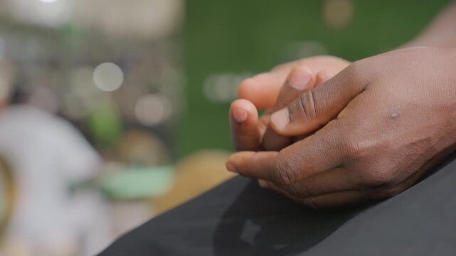 Closeup hands entwining on lap, fingertip caress with striped sleeve, slow palm clasp and reassuring squeeze, shallow depth bokeh background, intimate tension easing into mutual trust and emotional